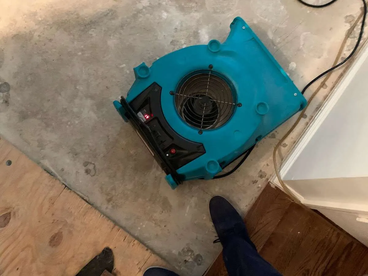 Air mover drying subfloor during Commercial Water Damage Restoration in Vancleave